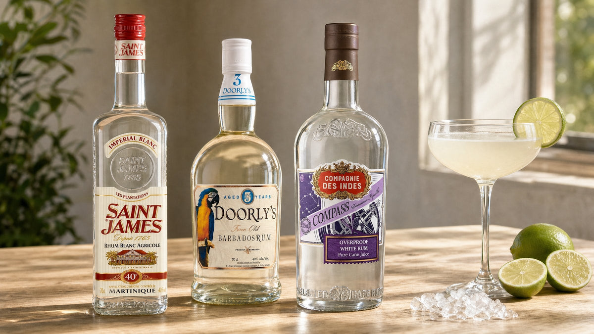 Saint James Rhum Blanc, Doorly's 3 Year Old and Compagnie des Indes Compass white rums beside a Daiquiri and limes